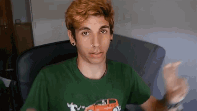 a man wearing a green t-shirt with a picture of a car on it