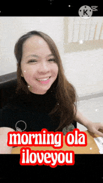a woman sitting at a table with the words morning ola i love you on the bottom