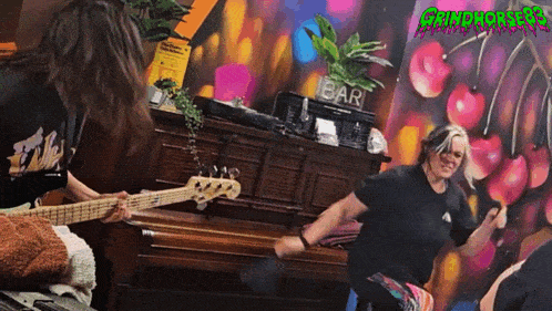 a woman playing a guitar in front of a sign that says " bar "