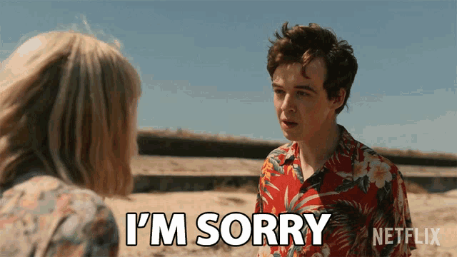 a man says i 'm sorry to a woman on the beach