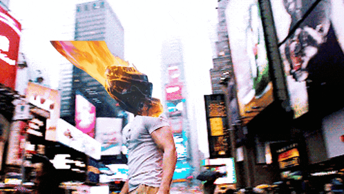 a man in a white shirt stands in a busy city street with a car on his face