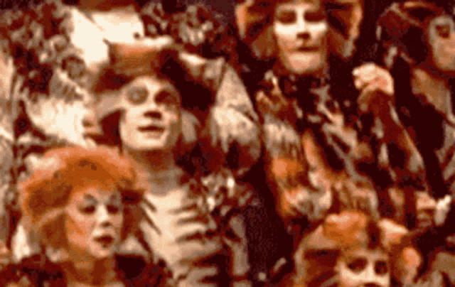 a painting of a group of people with their faces painted in different colors