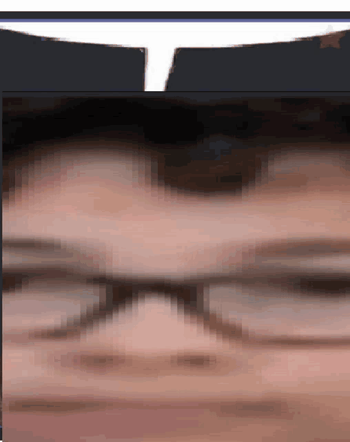 a blurry picture of a person 's face with glasses .