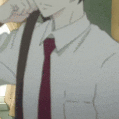 a man in a white shirt and tie sits in a room
