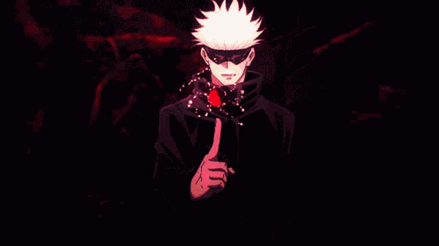 a man is giving a thumbs up sign in a dark room with red swirls around him .
