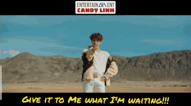a man standing in the desert with the words give it to me what i 'm waiting on the bottom