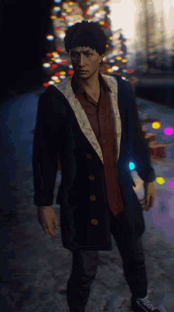 a man wearing a black coat and a red shirt is standing in front of a christmas tree