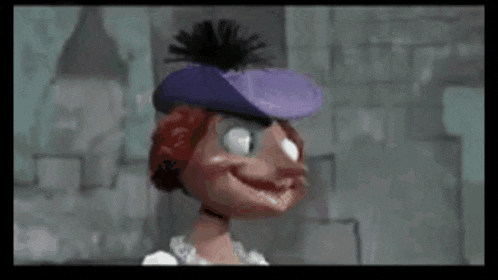 a cartoon character wearing a purple hat and a necklace is smiling .