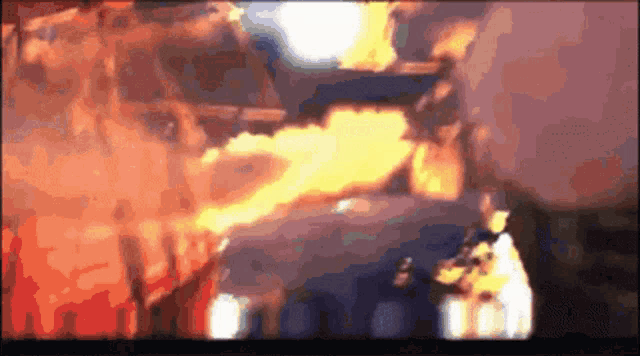a blurry picture of a man holding a gun with flames coming out of it