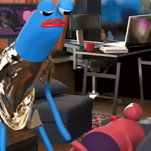 a blue frog is standing in front of a desk with a laptop