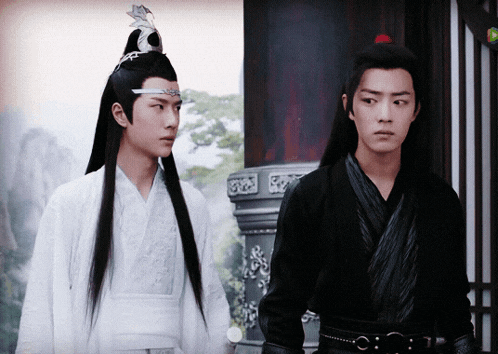 a man with a crown on his head stands next to another man