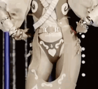 a close up of a woman 's torso and legs in a costume with hearts on it .