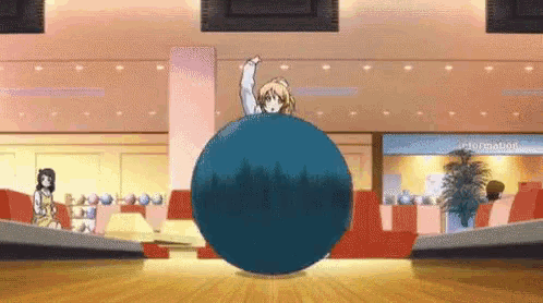 a girl is throwing a bowling ball in a bowling alley