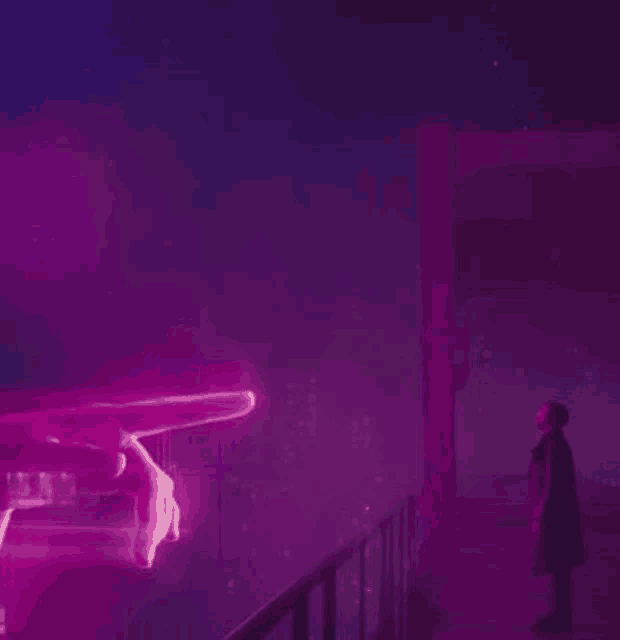 a man is standing on a balcony looking at a purple hand .