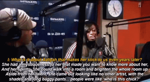 a woman talking into a microphone in front of a siriusxm clock