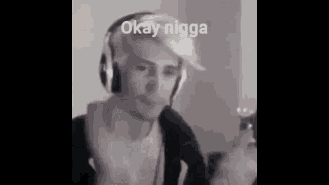 a man wearing headphones is making a funny face while playing a video game .