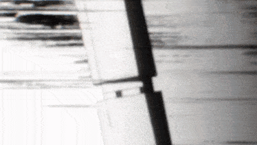 a black and white photo of a building with a reflection