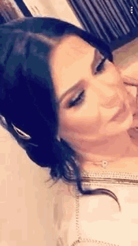 a close up of a woman 's face with dark hair