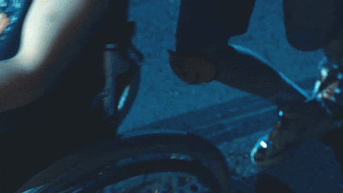 a man in a wheelchair is being pushed by a man in a crown