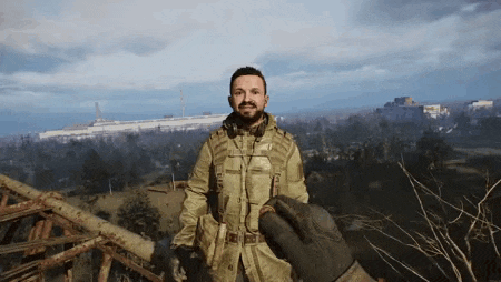 a man in a military uniform is standing on top of a wooden structure .