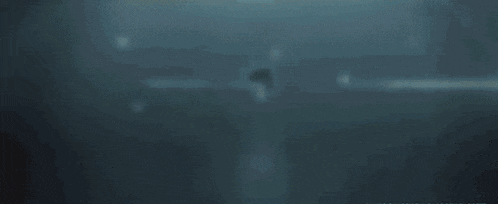 a blurry picture of a person standing in the water .