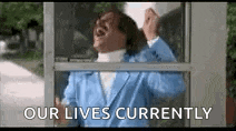 a man in a blue suit is standing in front of a phone booth and screaming .