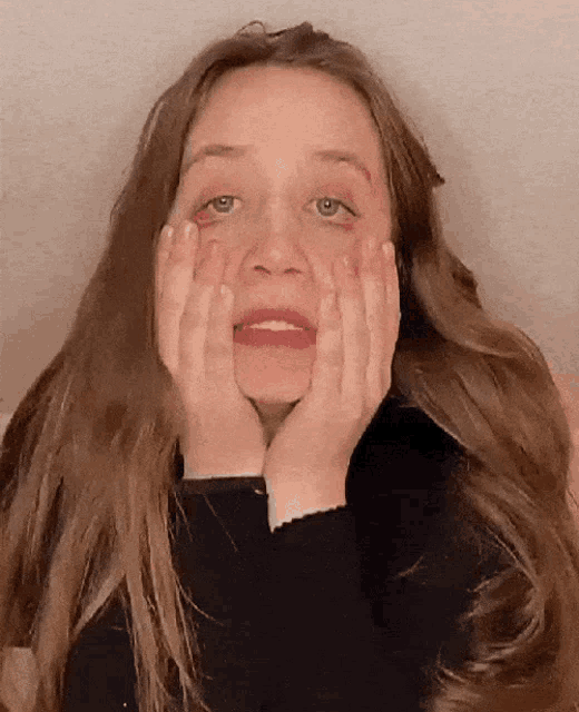 a woman with long hair is making a funny face
