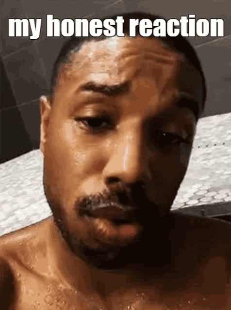 a shirtless man with a beard is taking a shower and making a funny face with the words `` my honest reaction '' .