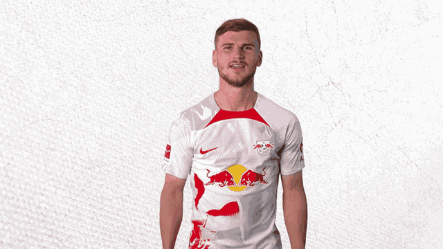 a man wearing a white shirt with red bulls on the front