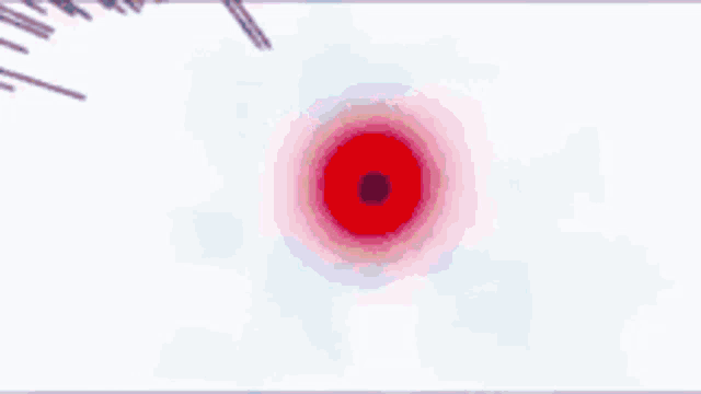 a pink and white explosion with a blue circle in the middle .