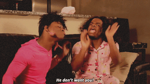 two men in pink pajamas are sitting on a couch and one of them says he does n't want you