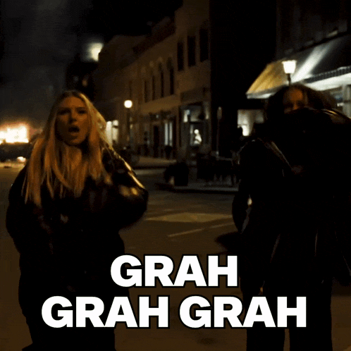 two women are walking down a street with the words grah grah grah written on the bottom