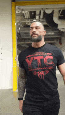 a man wearing a black t-shirt that says ytc