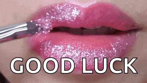 a close up of a woman 's lips with glitter on them and the words `` good luck '' .