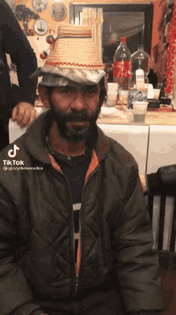 a man with a beard wears a straw hat and a tiktok video