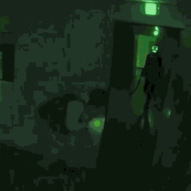 a man is standing in a room filled with boxes and a green light behind him