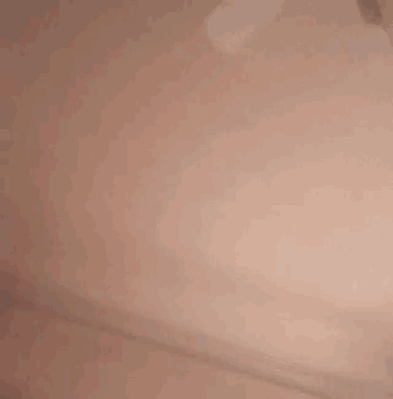 a close up of a person 's face with a pink background .
