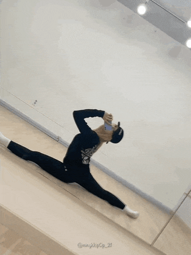 a person is doing a split in a dance studio with the hashtag @ min_kpop_21