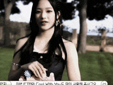 a woman in a black top holds a flower in her hand with the words " cool with you " on the bottom
