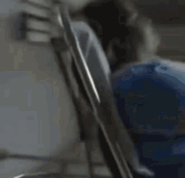 a man is laying in a hospital bed with his head on the arm of the bed .
