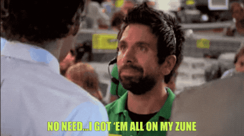 a man in a green shirt says no need i got ' em all on my zune