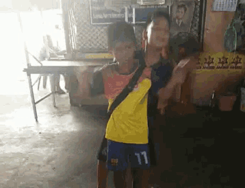 a boy in a yellow shirt with the number 17 on it