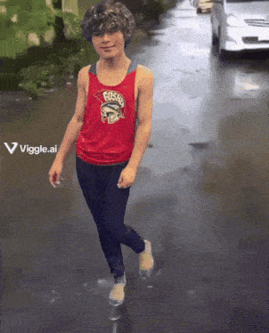 a young boy wearing a red tank top that says fusion