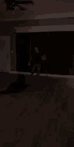 a man is playing a guitar in a dark room