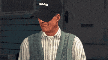 a man wearing a black saab baseball cap