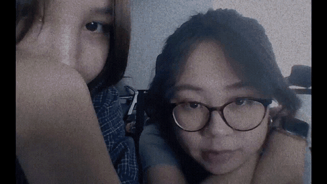 two girls wearing glasses pose for a picture together