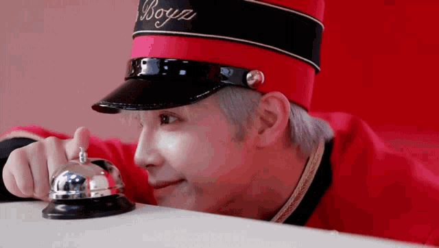 a man wearing a red hat with the word boys written on it