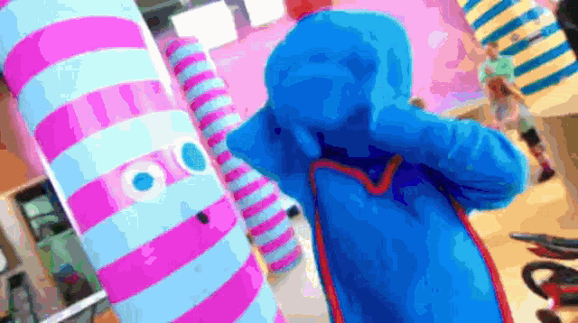 a person in a blue and pink striped outfit