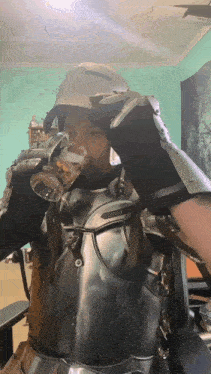 a man in armor drinks from a glass