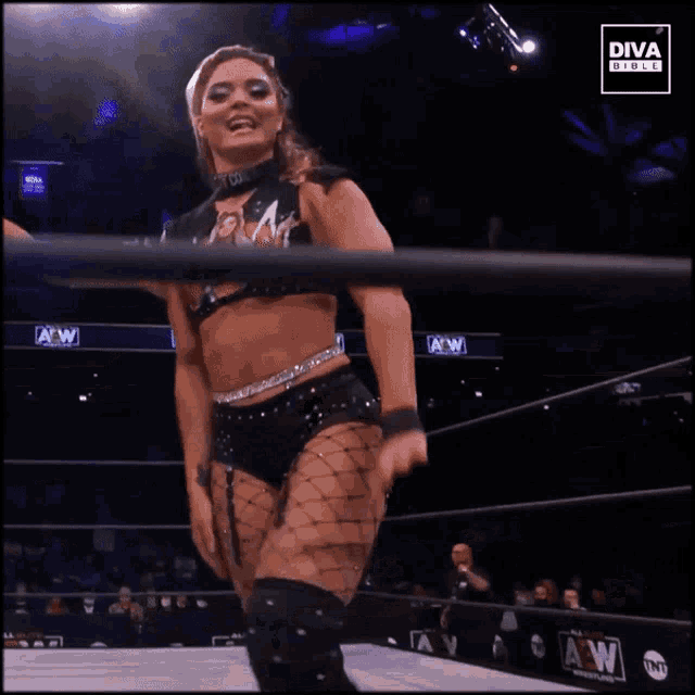 a woman in a wrestling ring with a diva girls logo on the bottom